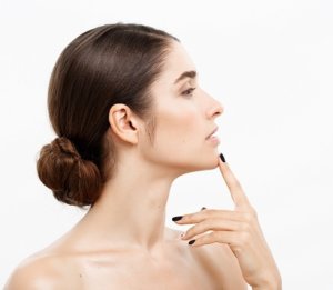 woman face portrait touching her chin with finger shocked and worried