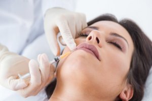 woman getting botox cosmetic injection in her face.
